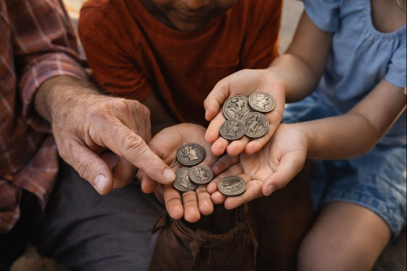Three people holding coins in their hands
